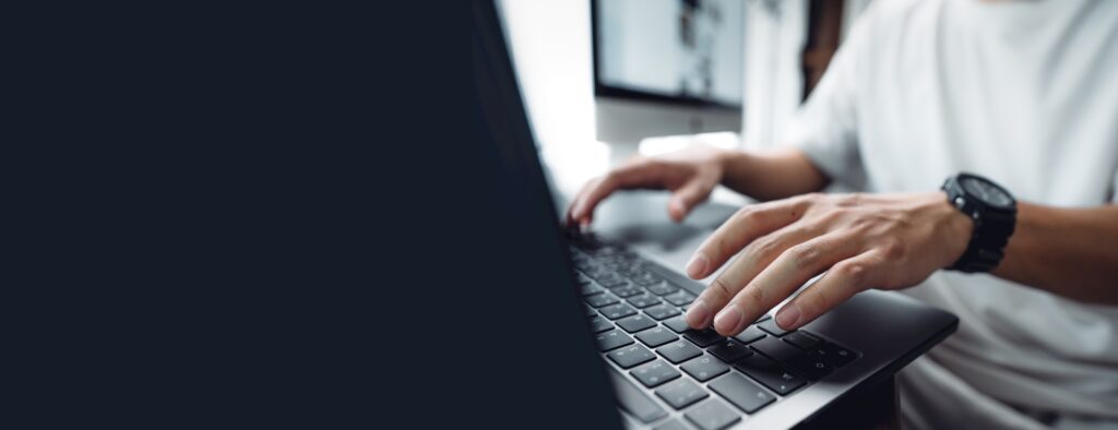 hands working on a laptop computer